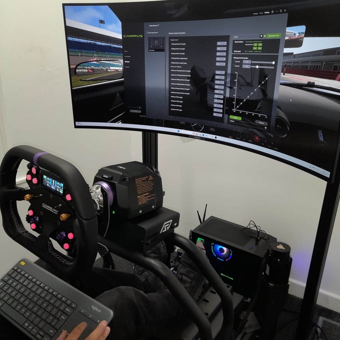 Racing simulator setup with steering wheel, pedals, and multiple monitors displaying racing game.